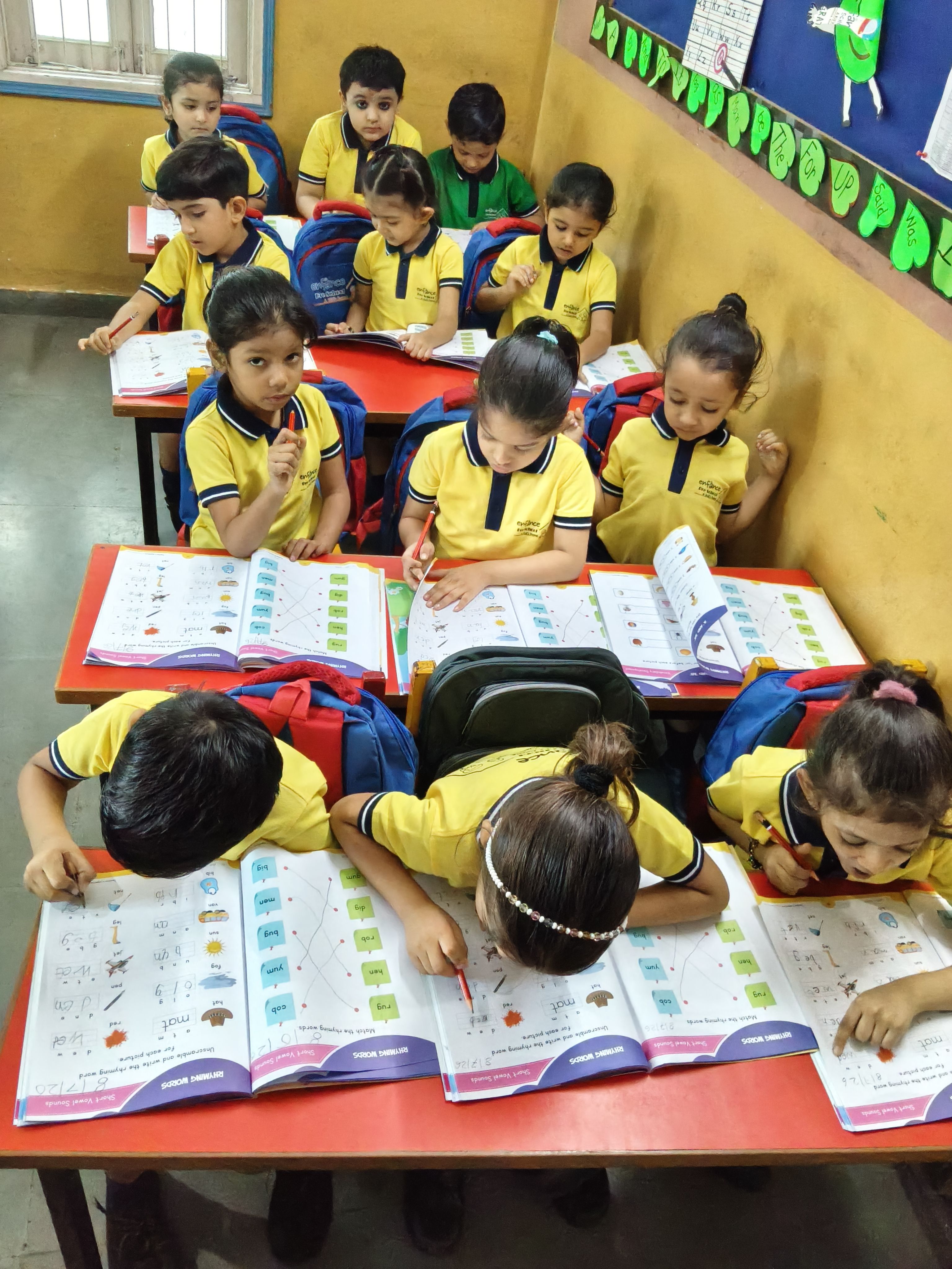 Child reading a picture book with teacher